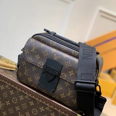Brown monogram crossbody bag with a wide black strap